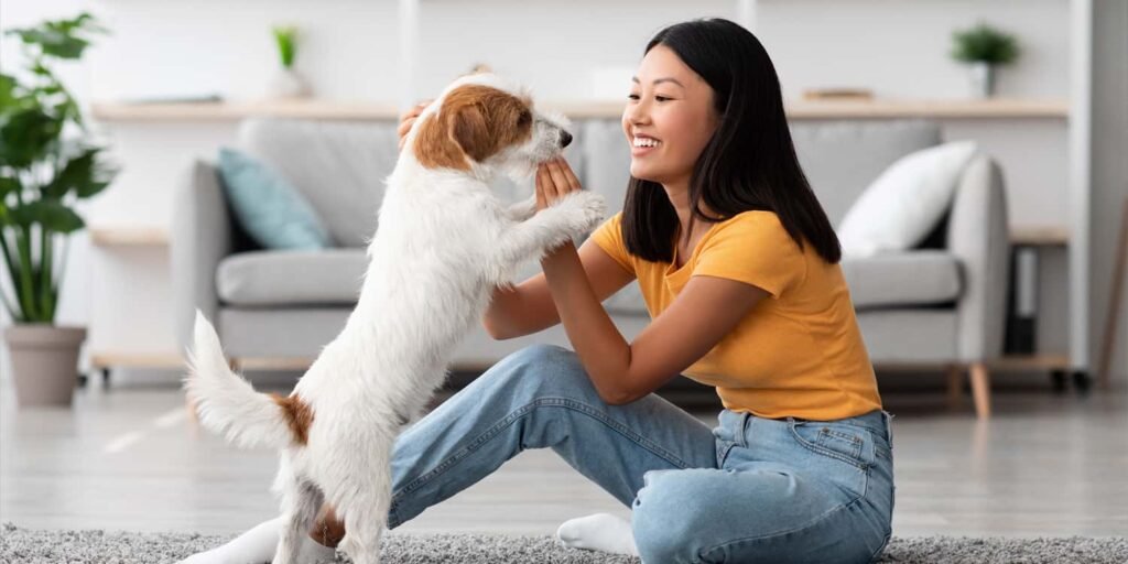 A woman uses a high-pitched voice when talking to an unfamiliar dog. A woman uses a high-pitched voice when talking to an unfamiliar dog.